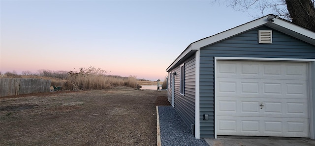 view of garage at dusk