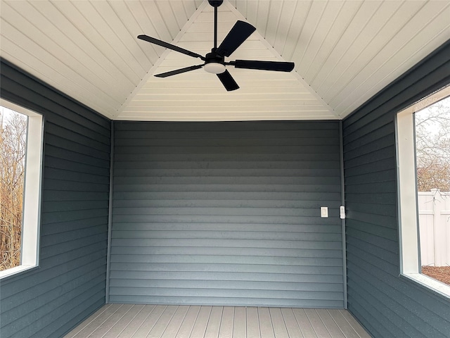 unfurnished sunroom featuring wood ceiling, lofted ceiling, and a wealth of natural light