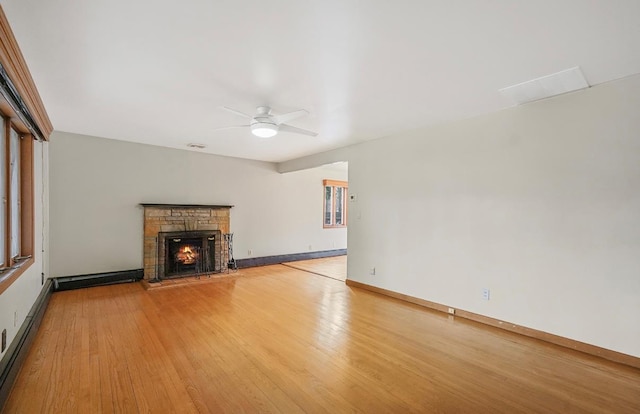 unfurnished living room with ceiling fan, baseboard heating, and light hardwood / wood-style floors