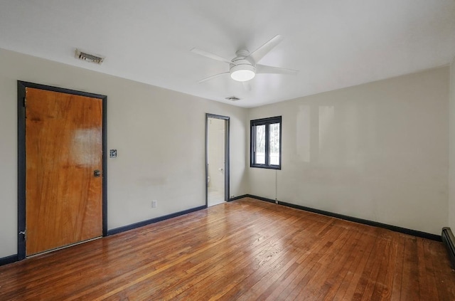 spare room featuring hardwood / wood-style floors and ceiling fan