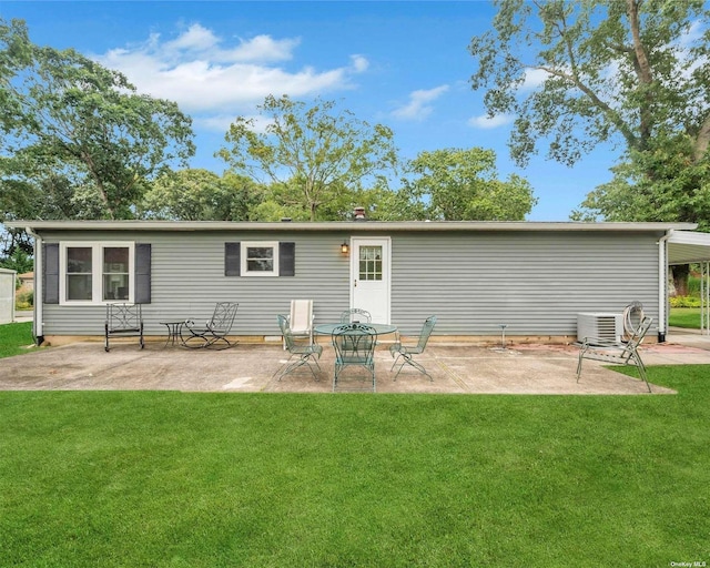 rear view of property with cooling unit, a yard, and a patio area