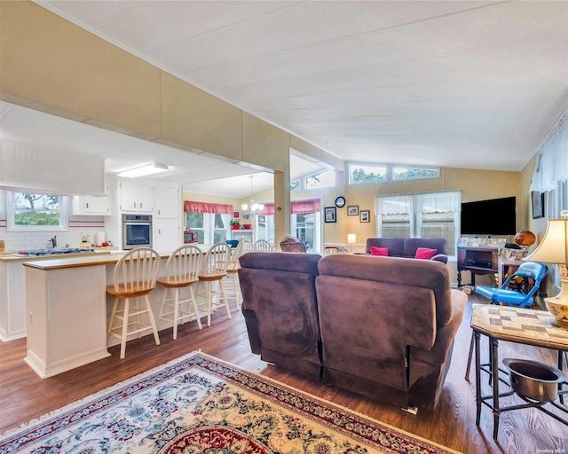 living room featuring lofted ceiling and dark wood-type flooring