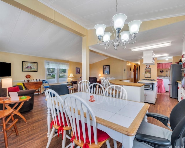 dining room featuring dark hardwood / wood-style flooring, vaulted ceiling, and a notable chandelier