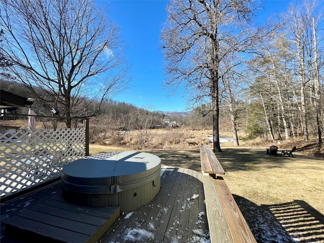 wooden deck featuring a covered hot tub