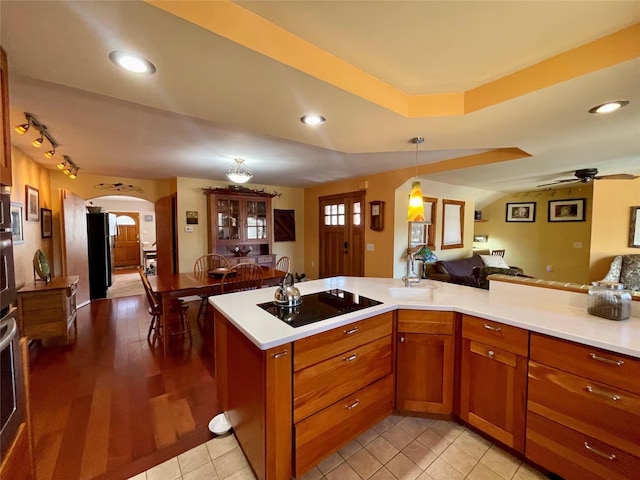 kitchen with light tile patterned floors, decorative light fixtures, black appliances, and ceiling fan