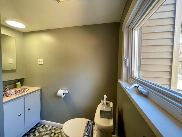 bathroom with vanity, plenty of natural light, and toilet