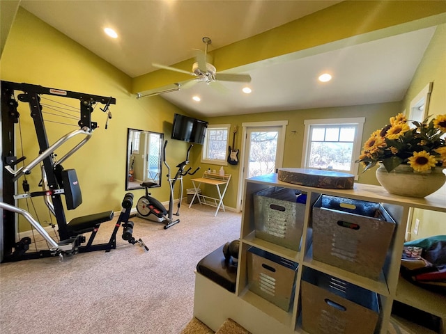 exercise room featuring ceiling fan, vaulted ceiling, and carpet