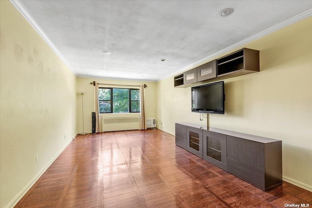 unfurnished living room featuring ornamental molding, radiator, and a wall mounted air conditioner