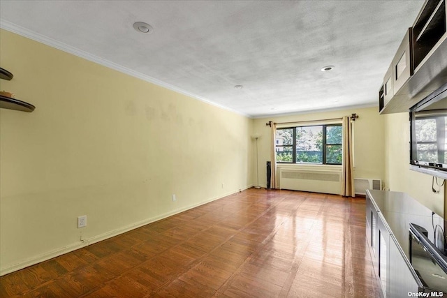 spare room with crown molding and radiator heating unit