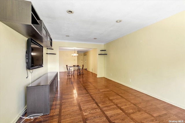 unfurnished living room with crown molding and dark hardwood / wood-style floors