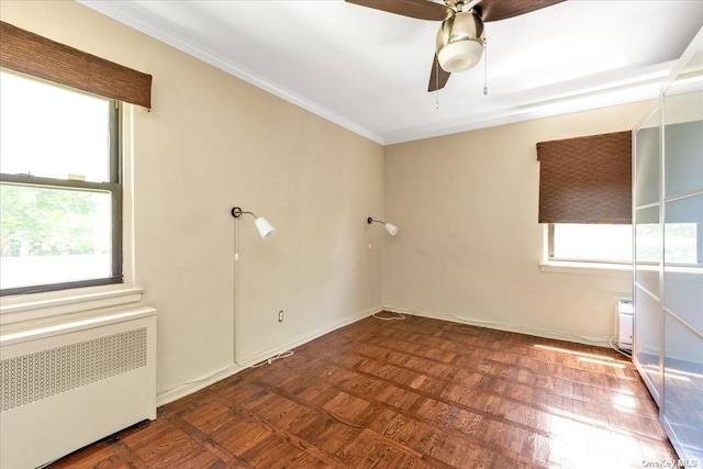 spare room featuring ornamental molding, radiator, and ceiling fan