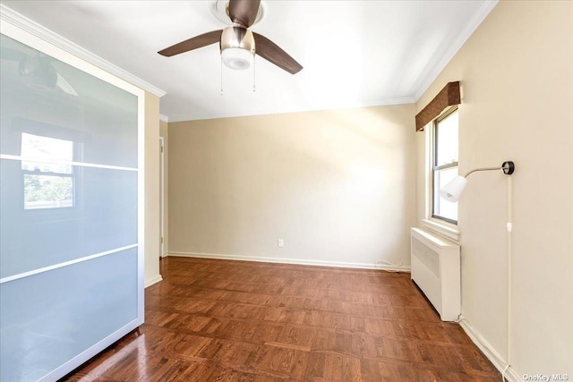 spare room with a healthy amount of sunlight, radiator, ceiling fan, and crown molding