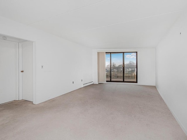 carpeted spare room featuring baseboard heating