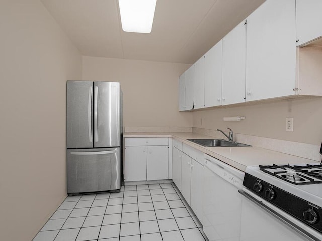 kitchen featuring white cabinetry, white appliances, light tile patterned flooring, and sink