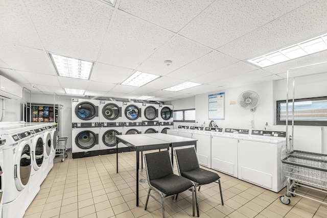 clothes washing area with light tile patterned floors, washing machine and dryer, and stacked washer / dryer