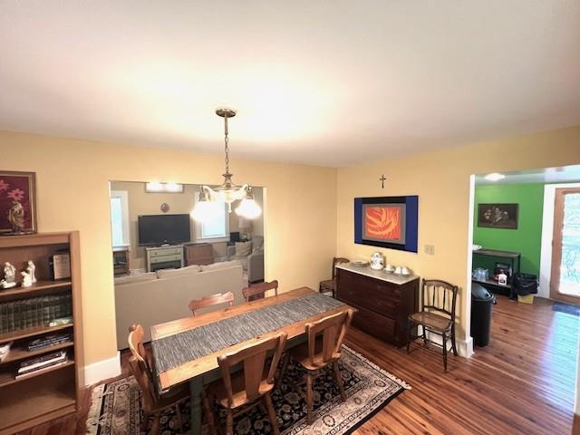 dining room featuring hardwood / wood-style flooring and a chandelier