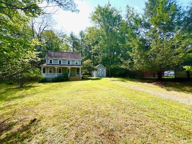 view of yard featuring a porch and a storage shed