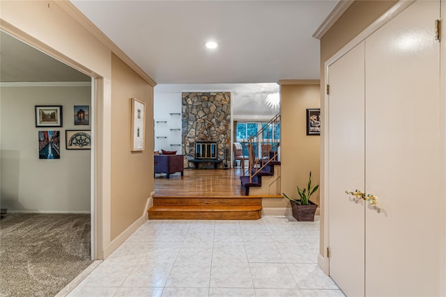 hall with ornamental molding and light tile patterned flooring