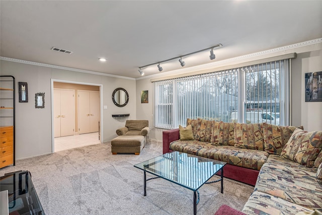 carpeted living room with track lighting and ornamental molding