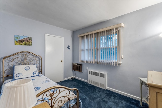 bedroom with radiator heating unit, dark carpet, and an AC wall unit