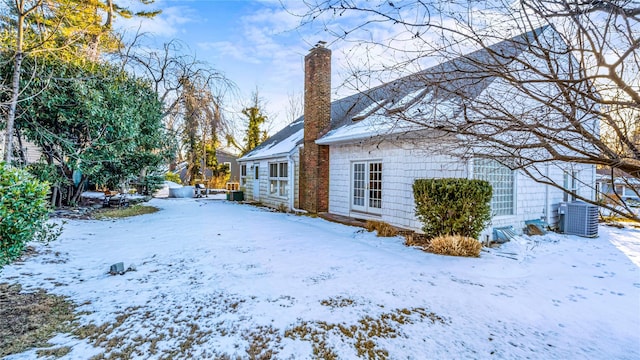 snowy yard featuring cooling unit