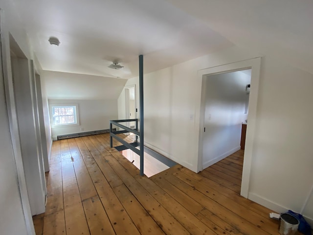 bonus room with hardwood / wood-style flooring, lofted ceiling, and baseboard heating