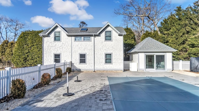 back of house with a patio, an outdoor structure, and a covered pool