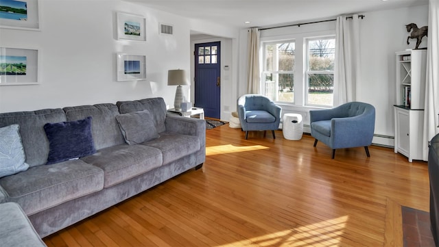 living room featuring hardwood / wood-style flooring and baseboard heating