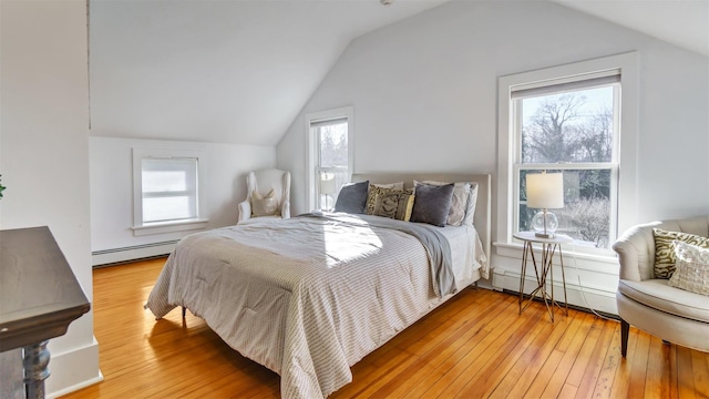 bedroom featuring multiple windows, hardwood / wood-style floors, and baseboard heating