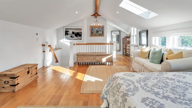 bedroom with a notable chandelier, light hardwood / wood-style flooring, and vaulted ceiling with skylight