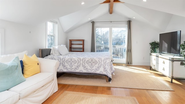 bedroom featuring multiple windows, access to exterior, light hardwood / wood-style flooring, and vaulted ceiling with beams