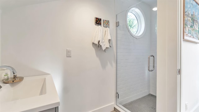 bathroom featuring an enclosed shower and sink