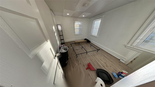 interior space with hardwood / wood-style flooring and a paneled ceiling