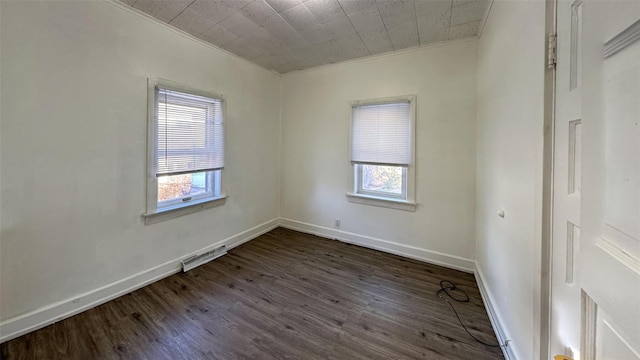 spare room featuring dark hardwood / wood-style floors