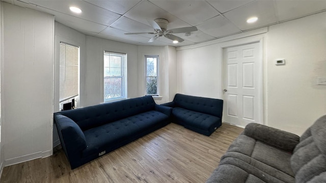 living room featuring hardwood / wood-style floors and ceiling fan