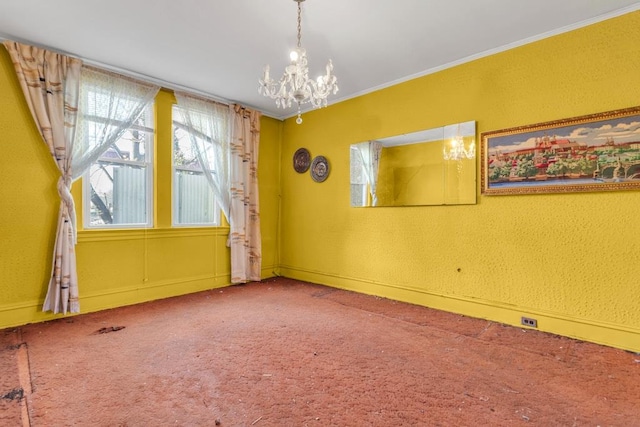 carpeted empty room with ornamental molding and a chandelier