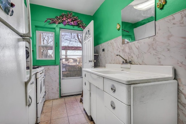 bathroom with vanity, tile patterned flooring, and tile walls