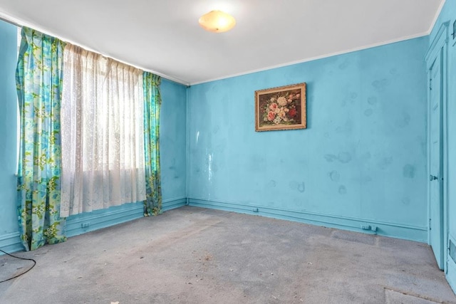 unfurnished room with light carpet and crown molding