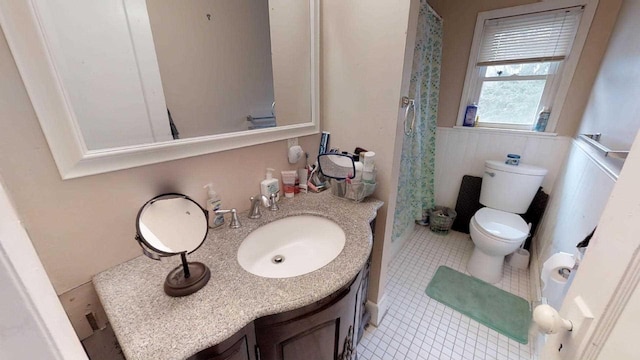 bathroom with vanity, tile patterned flooring, and toilet