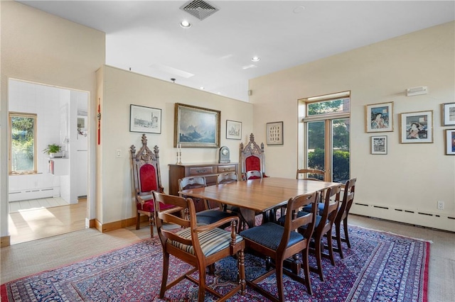 dining area featuring a healthy amount of sunlight and baseboard heating