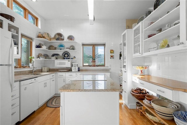 kitchen featuring a kitchen island, sink, white cabinets, white appliances, and light hardwood / wood-style flooring