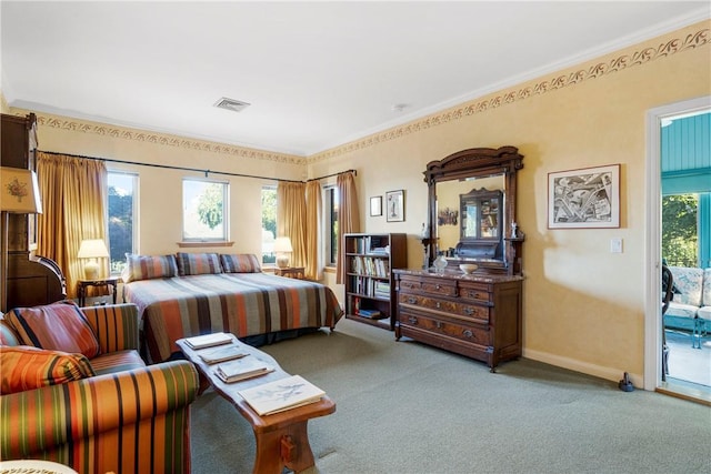 carpeted bedroom featuring crown molding and access to exterior