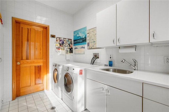 washroom featuring tile walls, sink, cabinets, and light tile patterned flooring