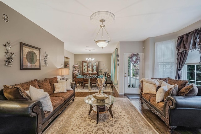 living room with hardwood / wood-style flooring and an inviting chandelier