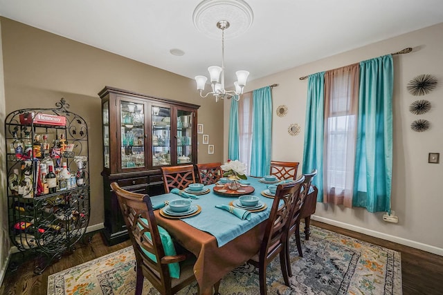 dining room featuring dark hardwood / wood-style flooring and a chandelier