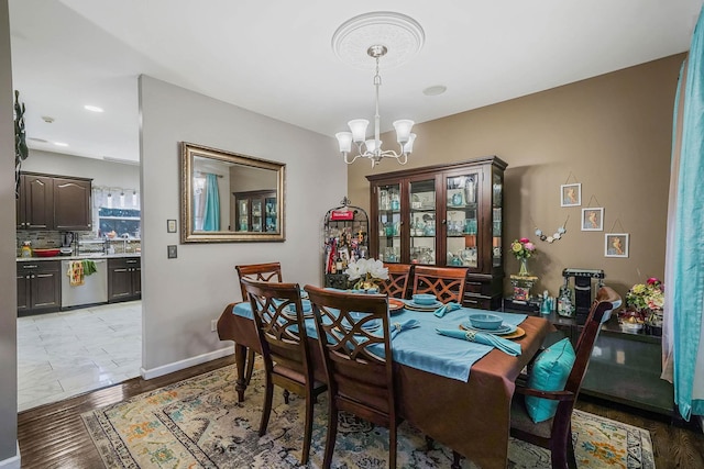 dining room featuring a chandelier and light hardwood / wood-style floors