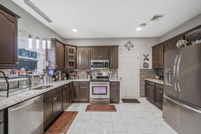 kitchen featuring sink, dark brown cabinets, and stainless steel appliances