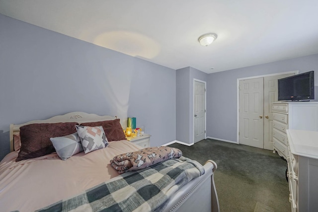 bedroom featuring a closet and dark colored carpet