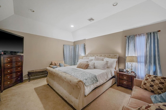 carpeted bedroom with lofted ceiling