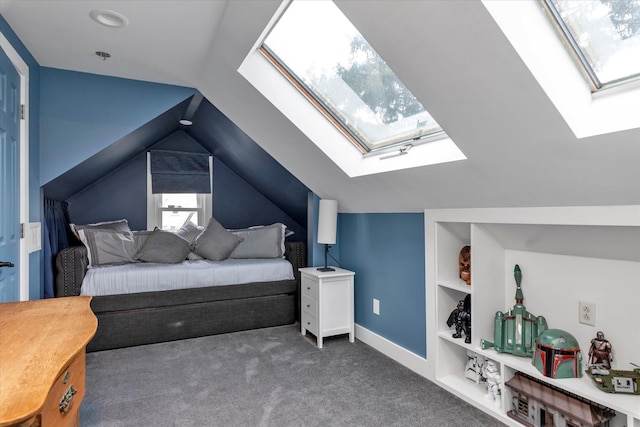 bedroom with dark carpet and lofted ceiling with skylight